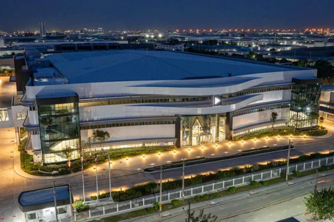 Large modern industrial building illuminated at night.