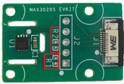 Figure 3. Highlights the location of R1 and R2 pads with red boxes on the MAX30205EVSYS. Figure 3. Highlights the location of R1 and R2 pads with red boxes on the MAX30205EVSYS.