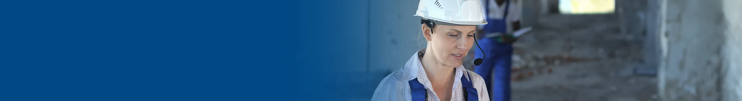  Female construction worker in hard hat and headset.