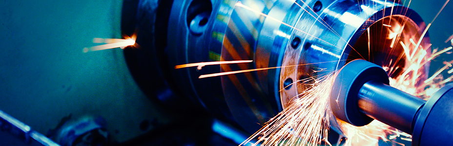 Close-up of metal grinding machine in action.