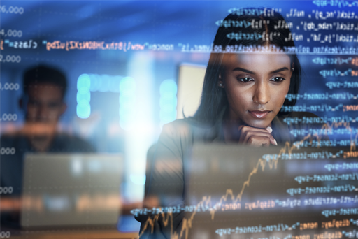 a woman looking at her laptop with an overlay of code