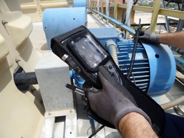 Figure 1. Manual inspection of equipment using piezo sensors and a handheld logger.