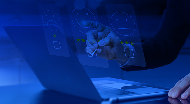 Business professional interacting with a digital feedback interface on a laptop, selecting a five-star rating with a smiley face.