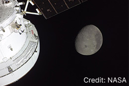 Spacecraft and solar array next to the Moon