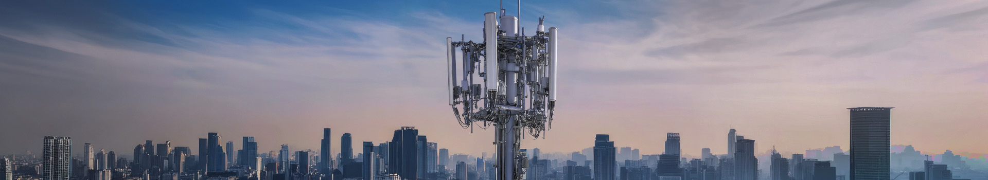 Large cellular base station tower with multiple antennas against a city skyline, representing 5G network deployment.