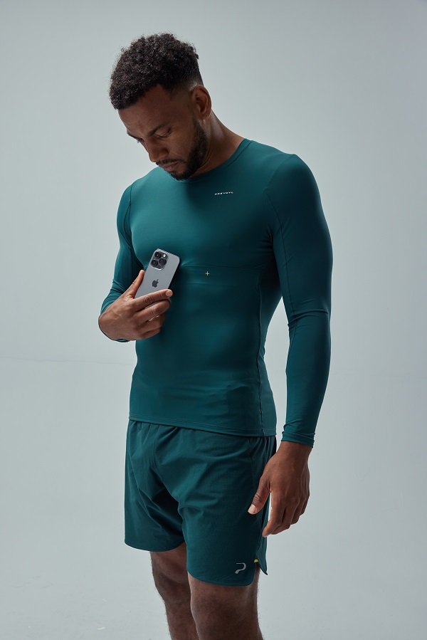 A man holding a phone next to Prevayl Sensor