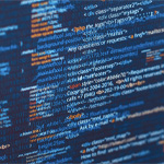 Close-up view of computer code displayed on a dark screen with syntax highlighting.