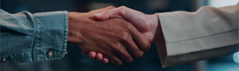 Close-up of two people shaking hands in a professional setting.