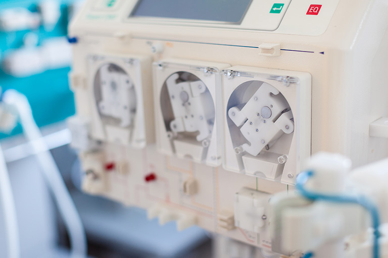 Dialysis machine with three visible peristaltic pumps.