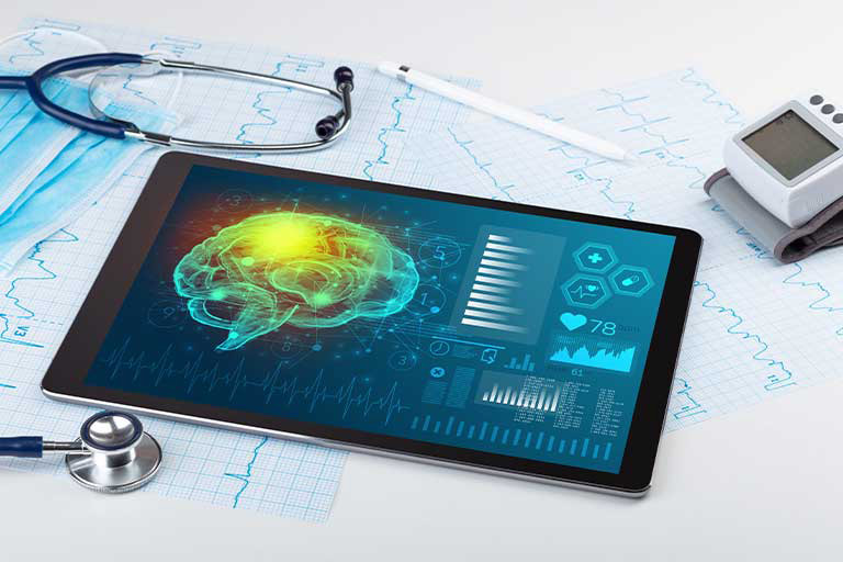Tablet showing brain scan & medical data with stethoscope, BP monitor.