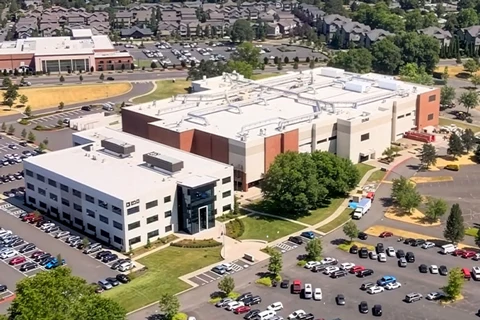 Aerial view of a modern corporate campus with full parking lots.