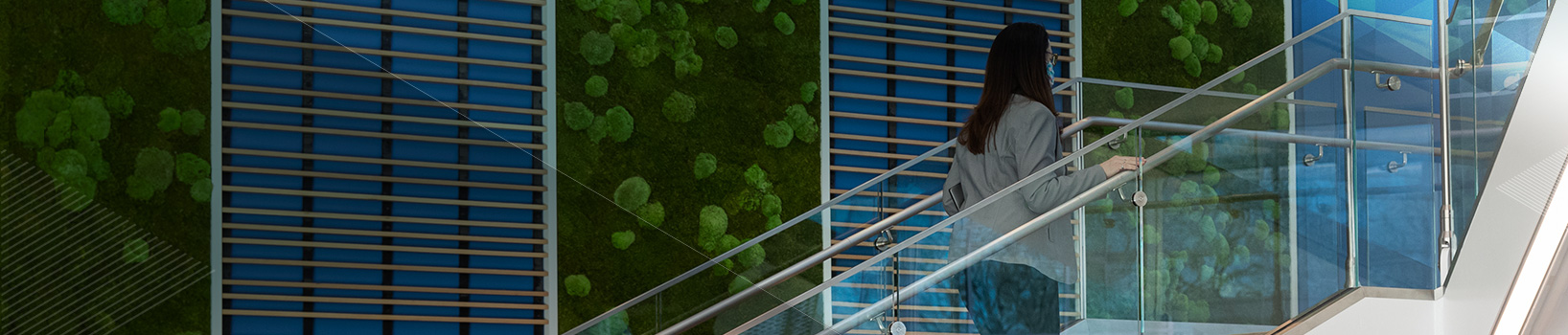 Woman walking up stairs in modern building