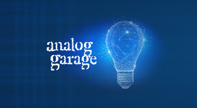 Digital lightbulb graphic next to the text 'analog garage' on a dark blue background