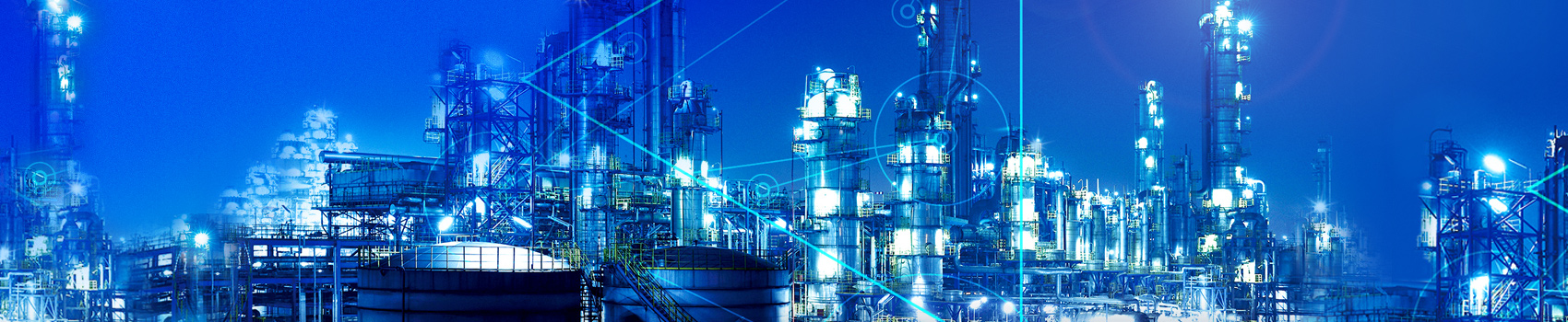 Image shows a gas refinery production plant at night.