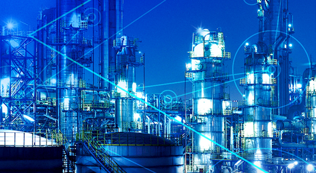 Image shows a gas refinery production plant at night.