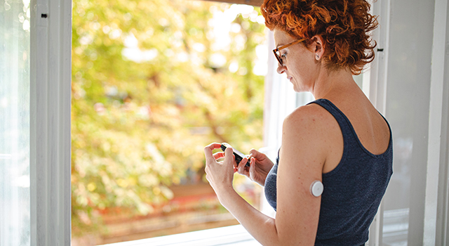 A woman checking her blood glucose levels.