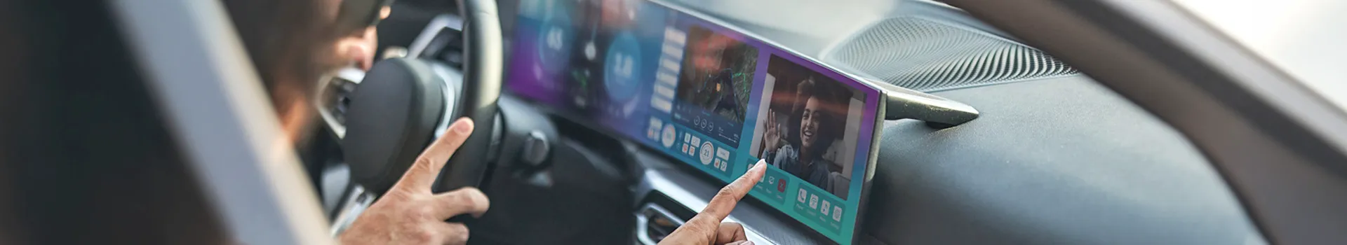 Hand touching car's wide screen displaying video call and map.