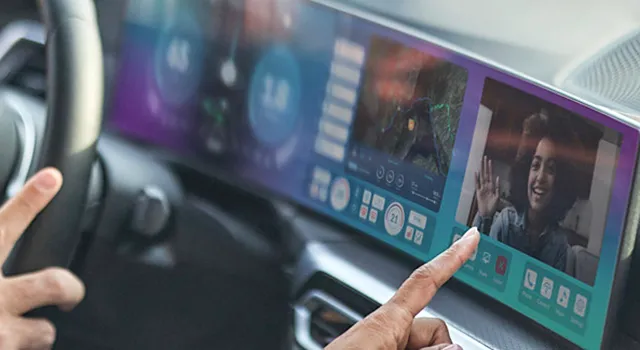 Hand touching car's wide screen displaying video call and map.