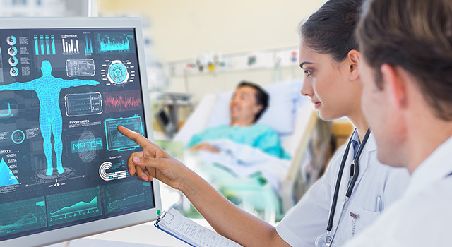 A doctor pointing to a medical chart on a digital screen