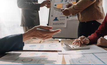 A group of 4 people having a meeting in a conference room.