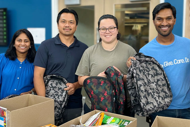 Group of employees packing up backpacks