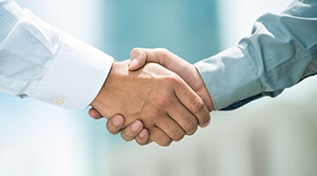 Close-up image of a firm handshake
