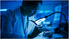 Engineer soldering motherboard in laboratory.