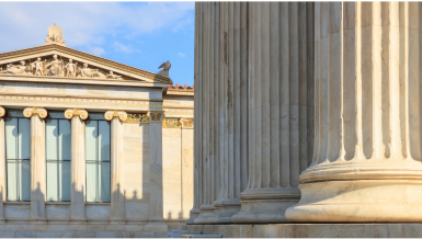 Government buildings with classic marble pillars on the façade of the building.
