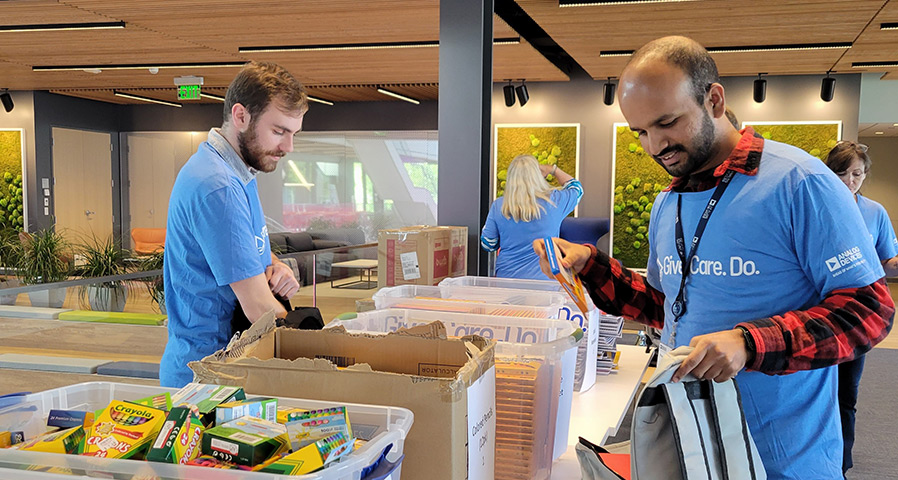 People donating their time putting gifts together