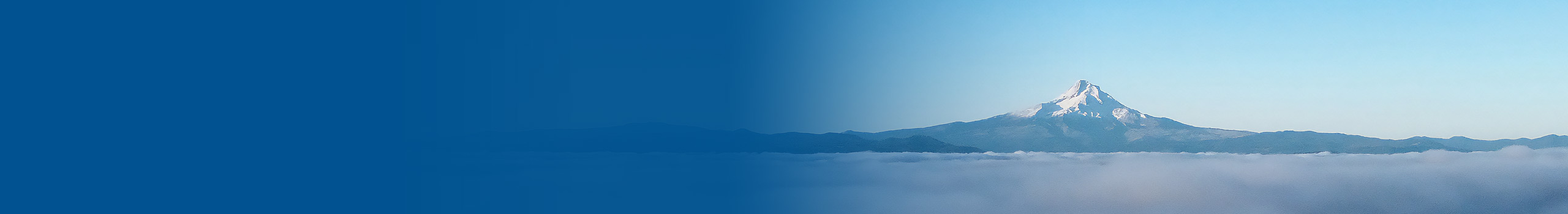 Snowy mountain peak rising above a sea of clouds, blue gradient.