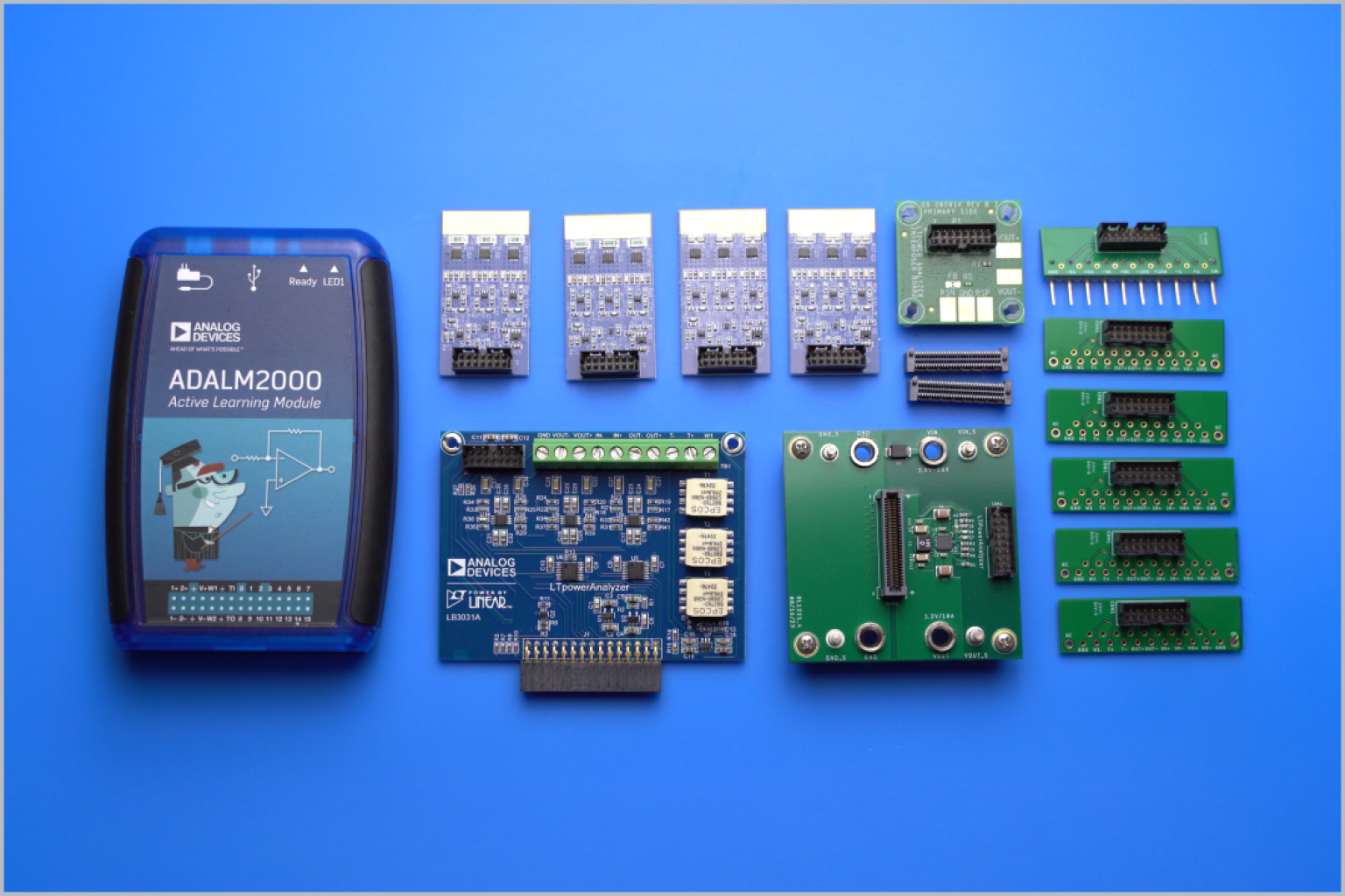 ADALM2000 Active Learning Module alongside various power management circuit boards, connectors, and components.
