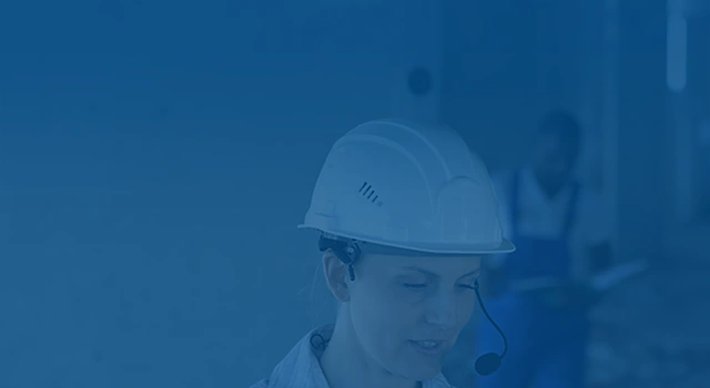  Female construction worker in hard hat and headset.
