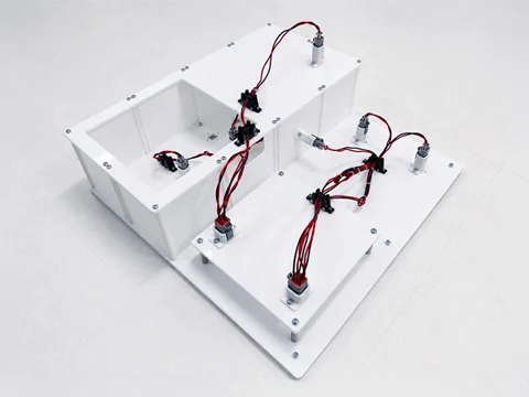 White modular electronic system with exposed wiring and motors.