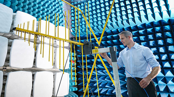 Scientist tests an antenna in an anechoic chamber