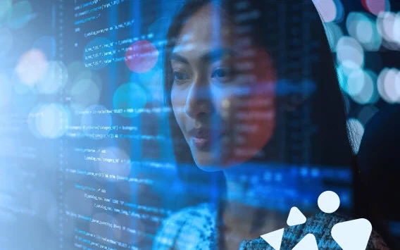 Woman looking at blue digital code and data overlaid on her face in the dark.