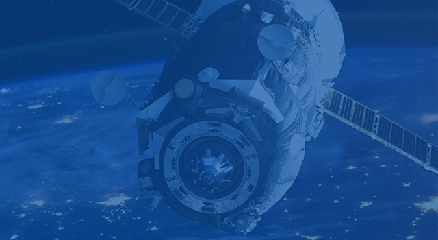 Satellite orbiting Earth with illuminated city lights and atmospheric glow in space view