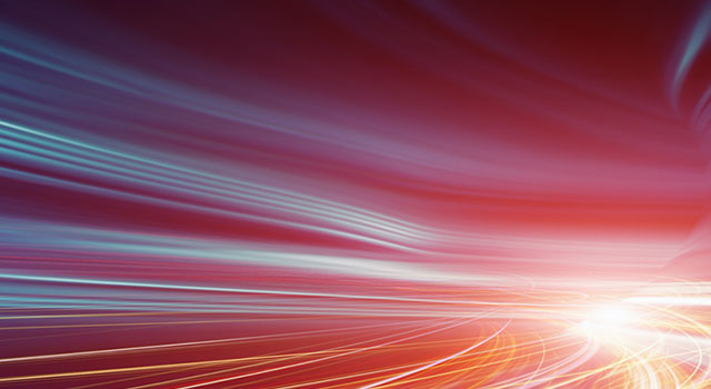 Abstract motion blur effect with red, blue, and yellow light trails creating a dynamic and futuristic visual flow.