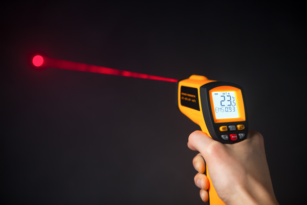 An infrared laser thermometer adjustable through hand pressure or touch.