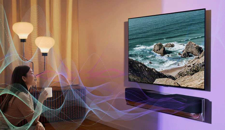 A woman being immersed in the sound coming from the beosound soundbar, making her feel like she is next to the ocean