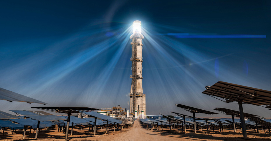 Heliostat panels and a brightly lite solar power receiving tower.