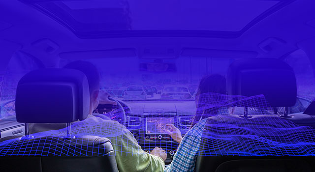 View from inside a car showing a driver and passenger surrounded by a digital visualization of sound waves
