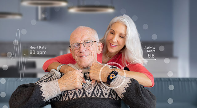 Elderly man wears the Tempo watch while being hugged by his daughter.