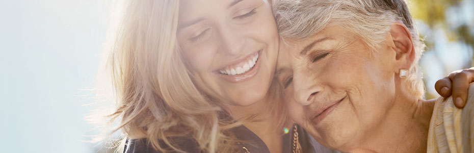 Happy senior woman spending quality time with her daughter outdoors.