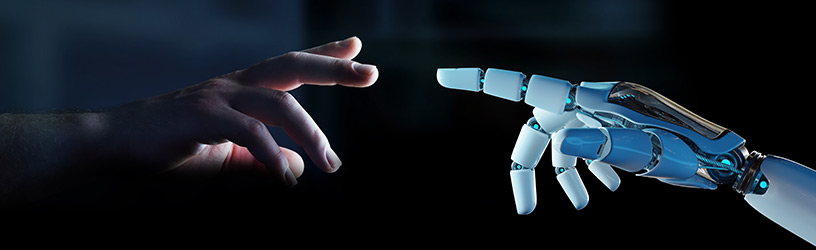 Human hand reaching for a robotic hand.
