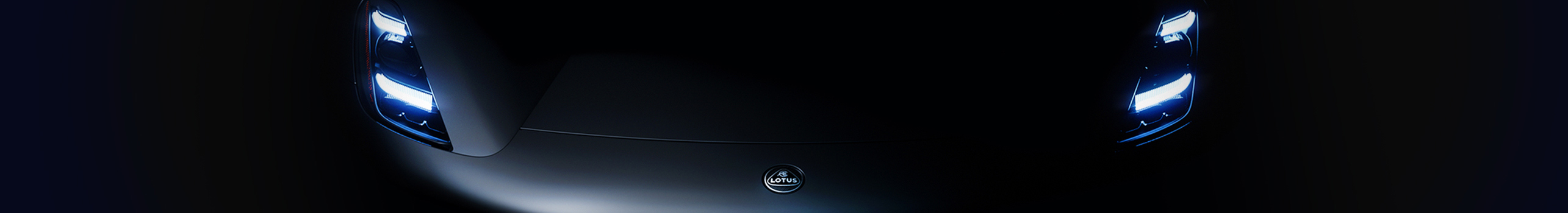 Front view of Lotus Car in dark environment with headlamps on
