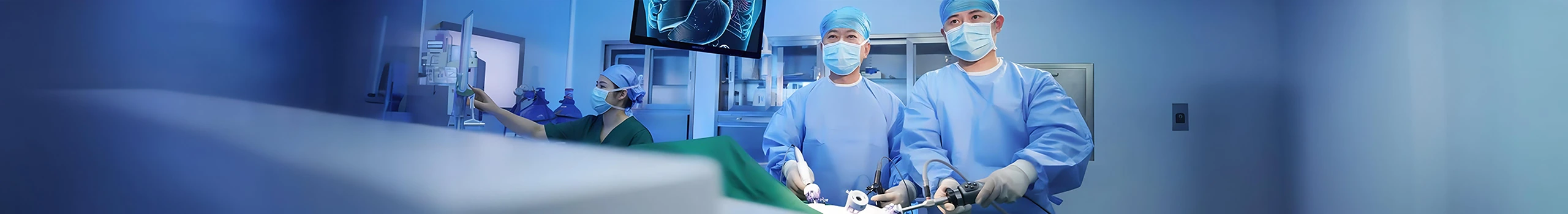 Surgeons in blue scrubs and masks performing laparoscopic surgery.