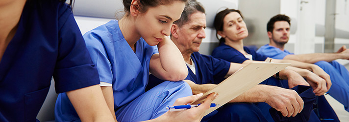 A group of medical personnel sitting on a bench