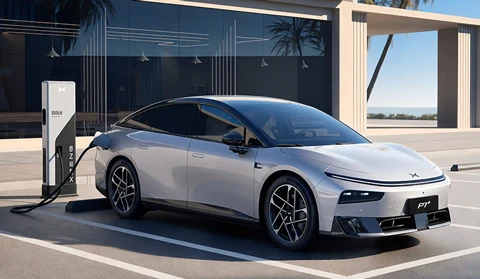 Silver Xpeng P7+ EV charging at a station with palm trees.