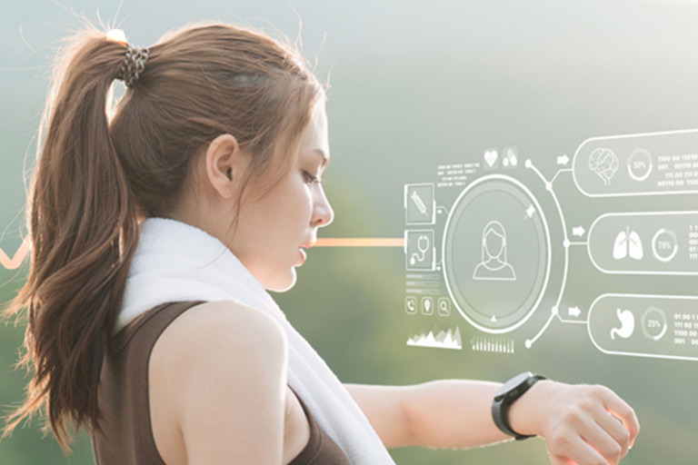 Woman checking smartwatch with holographic health data overlay.