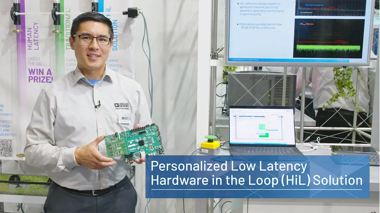An engineer presenting a low-latency HiL development kit designed for high-accuracy signal emulation.